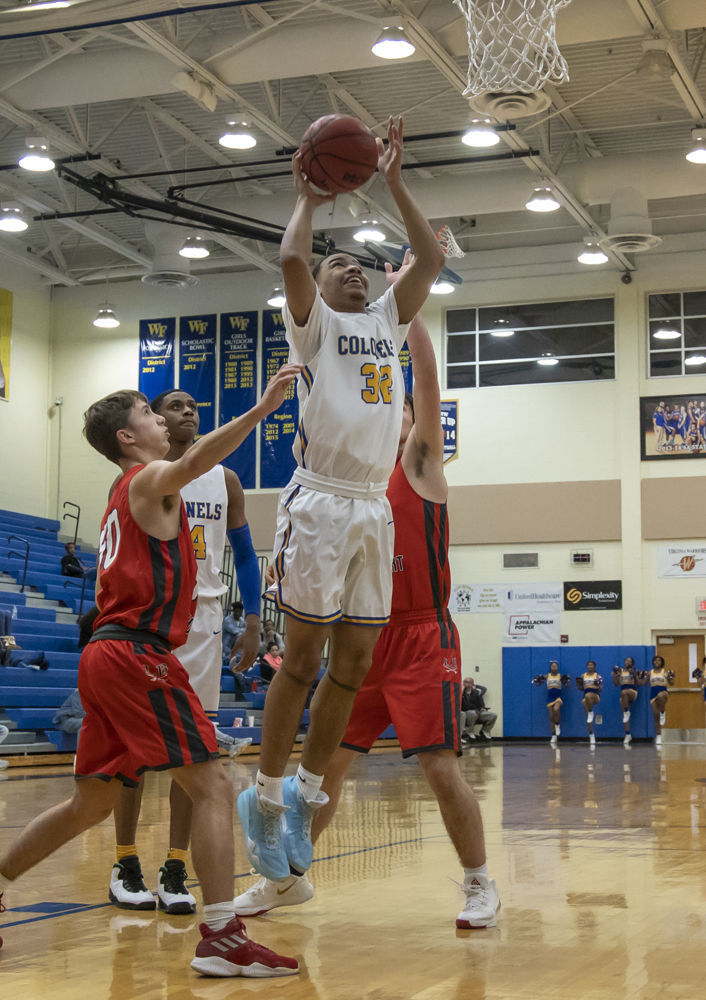 William Fleming's (32) Alexander Fuller goes up for the shot as Lord Botetourt's (50) Owen Prince and (11) Tanner Selkirk close in.
